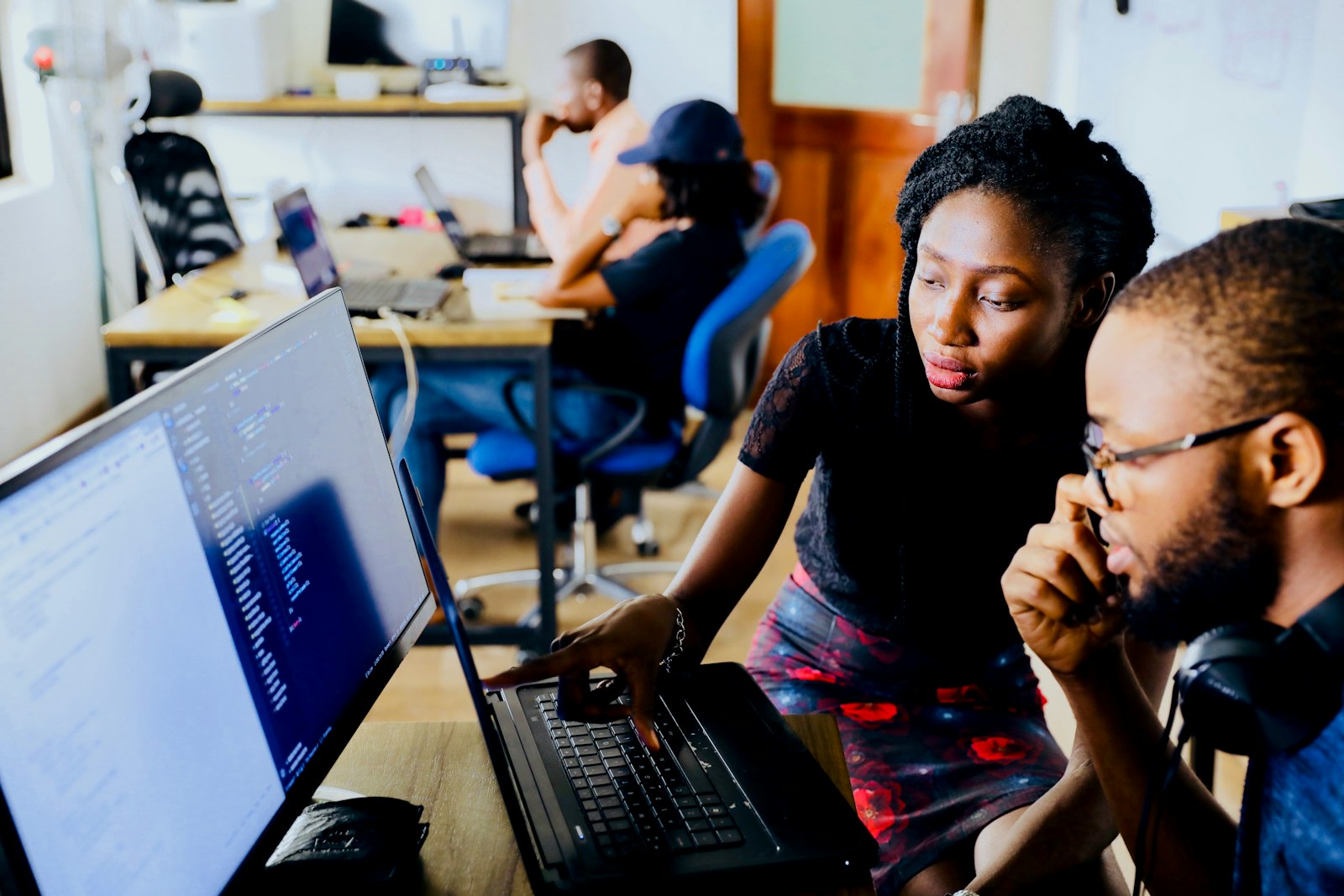 Engineers reviewing code together on a workstation